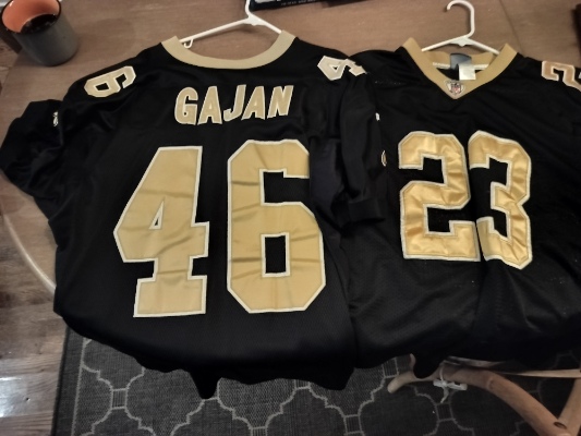 Authentic Saints Jerseys - Black with gold lettering - 46 Gajan and 23 (Thomas - nameplate not shown)